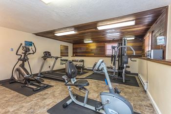 Indoor 24-Hour fitness center with cardio equipment available for use.